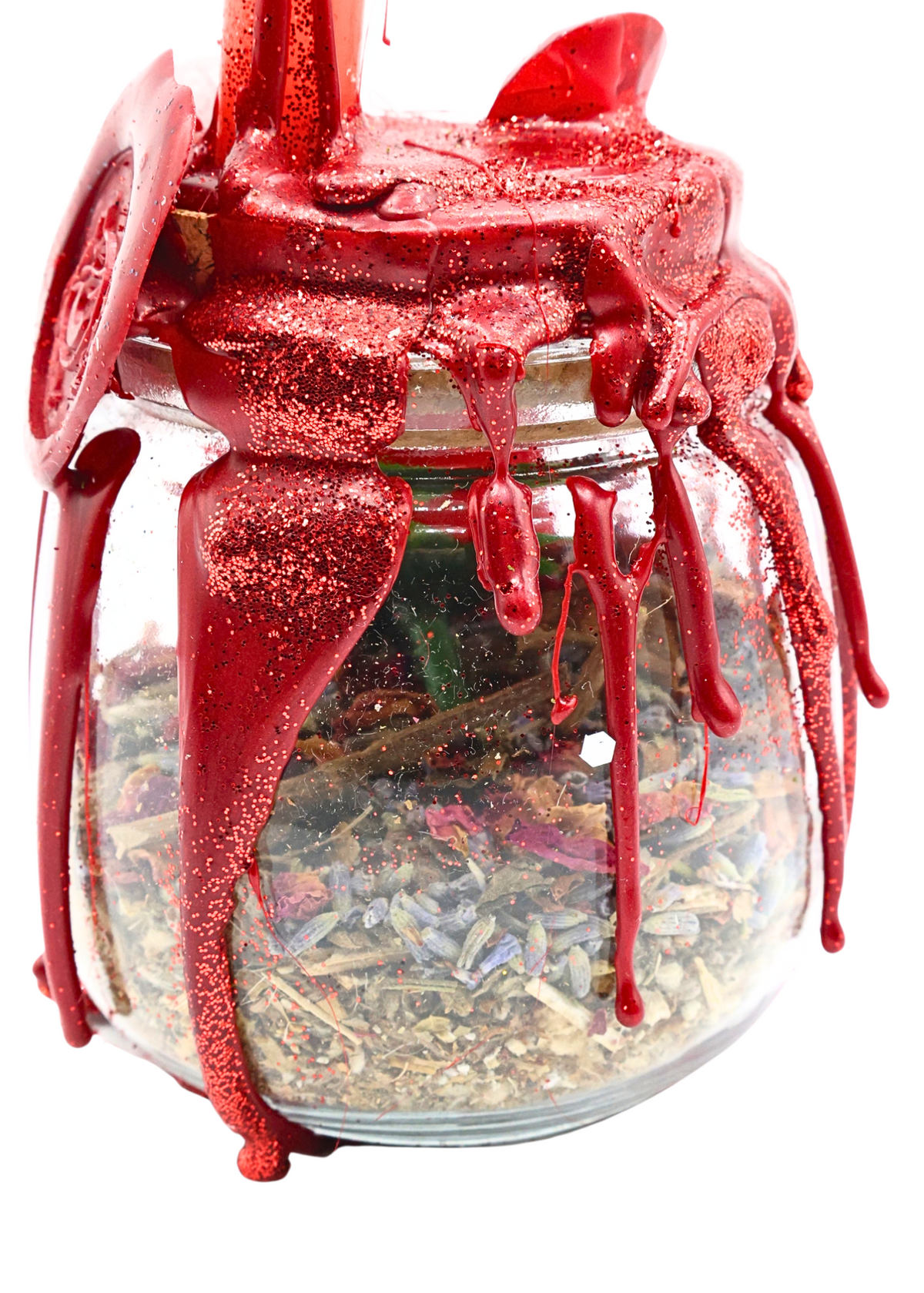 Close-up of Large Love Spell Jar showing sparkling red wax drips and dried herbs inside clear glass