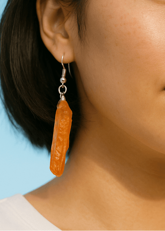woman wearing orange aura quartz earrings