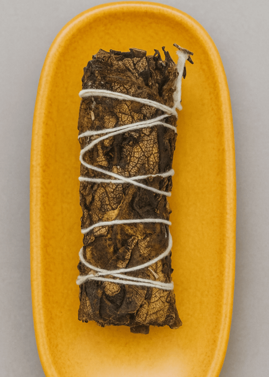black sage smudge stick on ceramic dish