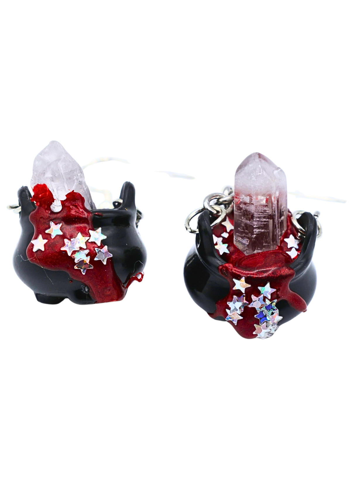 Close-up of handmade black and red crystal cauldron earrings with star details