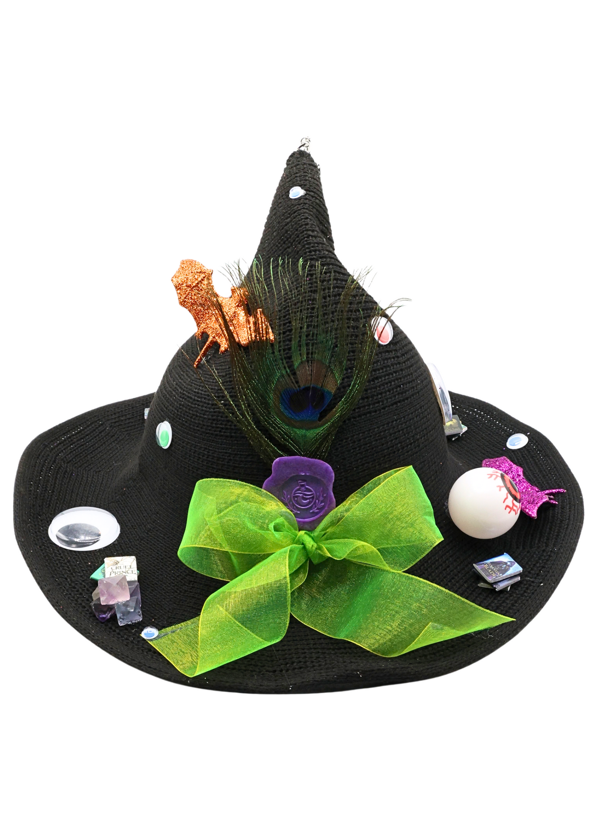 eyeball witch hat decorated by Tracie with decorative eyeballs, a bright green bow, a peacock feather, glittery bats and miniature book accents