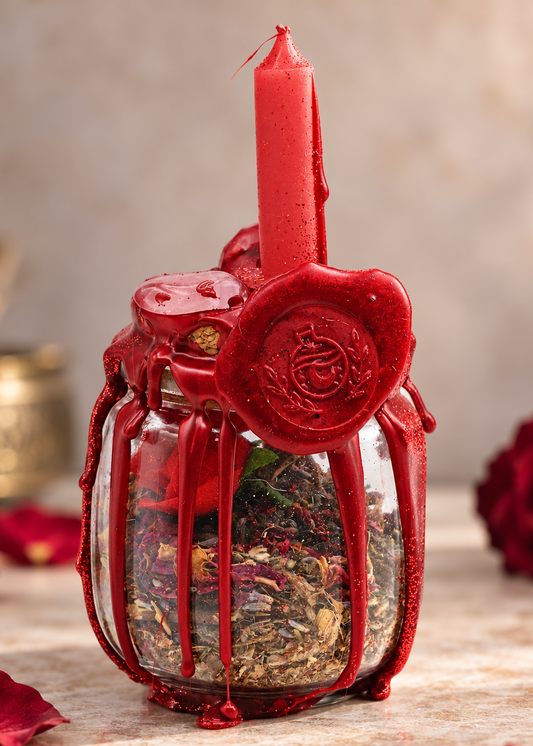 Large Love Spell Jar with red candle, crimson wax seal and dried botanicals on a soft romantic background