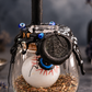 Large Protection Spell Jar with black candle, evil eye charm and protective herbs on a charcoal apothecary backdrop