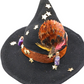 Spell bottle themed black woven witch hat decorated by Tracie, alternate view 1 showing miniature bottles, gold stars and orange ribbon