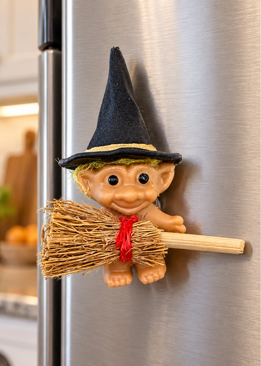 Troll witch refrigerator magnet on stainless steel fridge in a kitchen