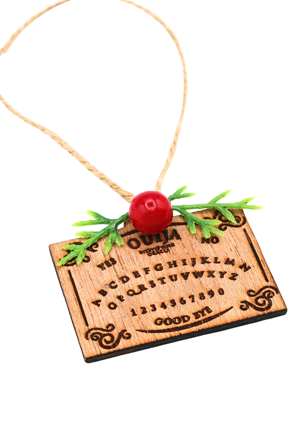 Wooden Ouija board holiday ornament shown at an angle with twine hanger